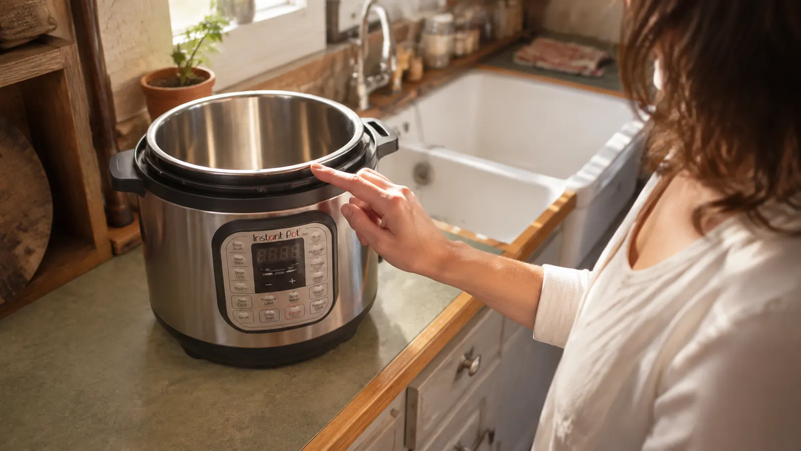 A hand checking the sealing ring on an Instant Pot Duo lid before locking it